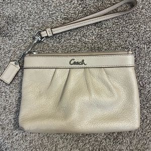 Small champagne Coach wristlet, leather with light purple interior